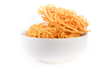 Crispy noodles in a white bowl on white background