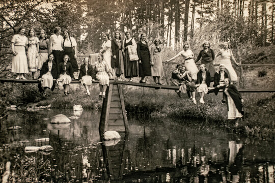 Latvia - CIRCA 1930s: Group photo on bridge in forest. Vintage archive Art deco era photo
