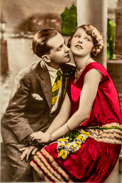 Germany - CIRCA 1920s: Vintage art deco era photo. Lovers sitting. Couple portrait in studio. Hand coloured photograph
