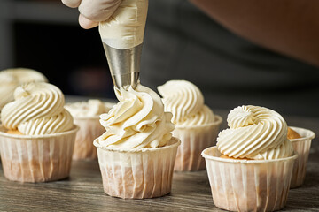 Closeup of a pastry chef making a cream from a bag