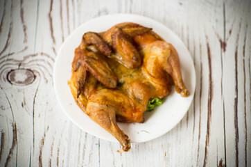 whole fried chicken in a plate on table