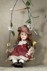 Toy doll on swing closeup