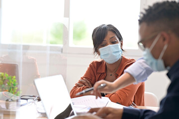Coworkers in open space office, wearing surgical face mask, 19-ncov pandemic