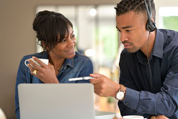 Start-up people working in co-working space office on laptop computer