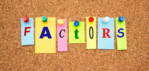 Color notes with letters pinned on a board. Word FACTORS.