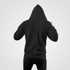 Black sweatshirt template on guy wearing hood, fashion hoodie, back view, isolated on white...