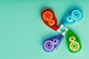 Stationery correction tapes are Multicolored on a blue background.