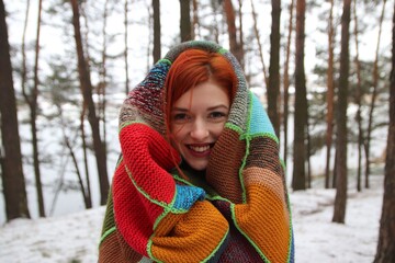 beautiful girl with red hair with a bright plaid