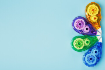 Stationery correction tapes are Multicolored on a blue background.