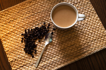 Hot coffee and coffee beans on the wooden table