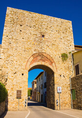 Fototapeta na wymiar The 14th century south gate in the city walls of the historic medieval village of Paganico near Civitella Paganico in Grosseto Province, Tuscany, Italy 