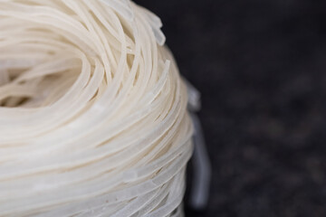 rice noodles nest on black stone background