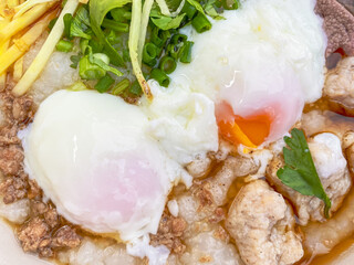 Close-up Pork Congee with Soft-boiled eggs is Asian breakfast. Food background