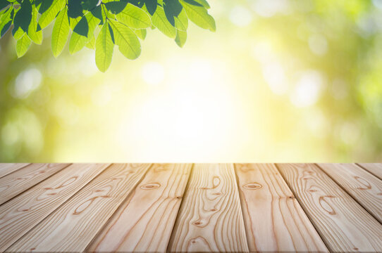 Empty wooden table with garden bokeh background with a country outdoor theme, Template mock up for display of product