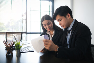 Two business people working on their new project in modern office.