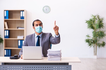 Young male employee wearing mask during pandemic