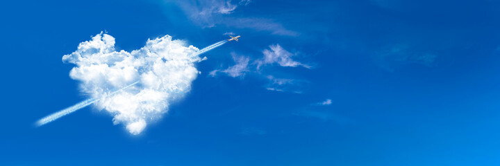 Cupid plane in a heart shaped cloud on blue panoramic sky background. Valentine's day web banner.