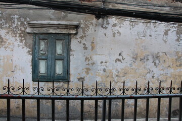 Old window on building at a small alley 