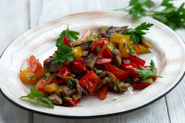 Fried vegetables in a plate on a light background