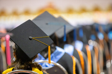 Graduation cap image from the back of graduates Graduates attending the university graduation...
