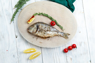 Cooked dorado fish in a plate.