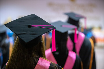 Graduation cap image from the back of graduates Graduates attending the university graduation...
