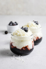 Coconut milk vegan dessert  rice pudding in glass jars. Space for text.