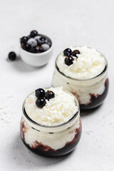 Vegan crockpot rice pudding with berries  in glass jars. Space for text.