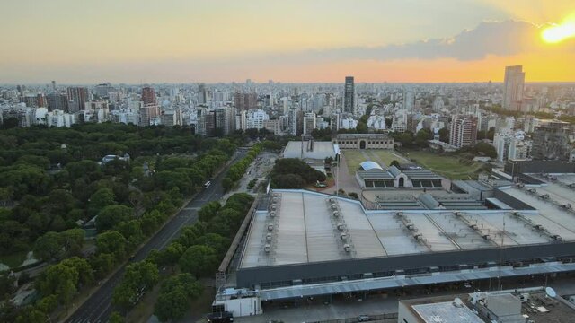 Buenos Aires drone view orbiting La Rural Exposition centre urban skyline cityscape at sunset