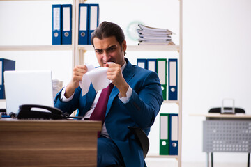 Young male employee working in the office