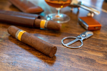 Fototapeta na wymiar Cuban cigar and smoking accessories on wooden desk