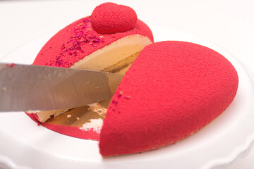 Red luxury mousse cake decorated with roses. Valentine's Day celebration. Love.