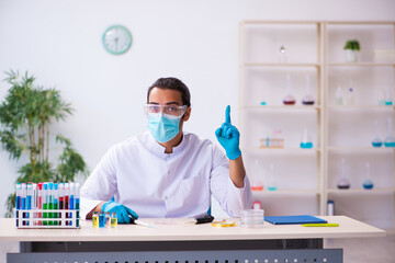 Young male chemist working in the lab