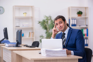 Naklejka premium Young male employee working in the office