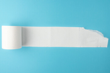 partially unrolled toilet paper roll isolated on blue background - obrazy, fototapety, plakaty