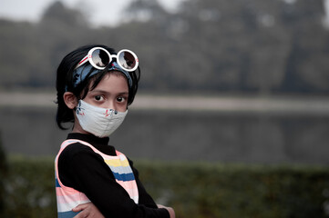 Kid girl with mask on face and in outdoor