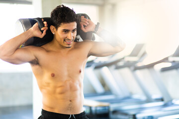 Obraz premium Portait Handsome young man while resting at gym. Man training in a gym Fitness.workout, exercises and healthy concept
