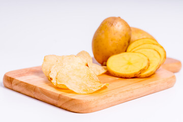 Organic potato on Wooden cutting board with isolated white background, Close up raw nature vegetable