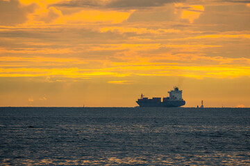 Obraz premium Logistics import export Container Cargo ship in seaport on sunset sky, Freight Transportation by container ship boat