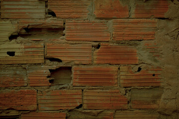 Background texture of old grunge broken bricks with striated pattern in a damaged wall in a full frame view