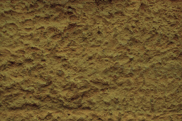 Background texture of a rough plaster wall surface in close up in a full frame view