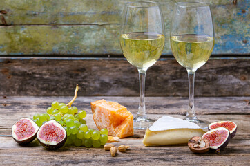 Set of cheese with figs, grapes and white wine