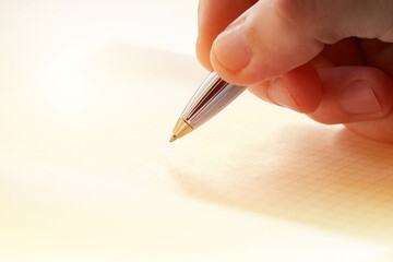 writing activity at blank diary or notebook close up macro. sunlight. paperwork and learning concept. minimal