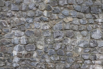 The texture of a fence made of stone.