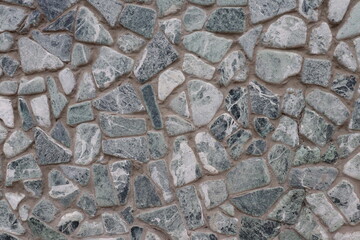 The lower part of the building wall is made of stone.