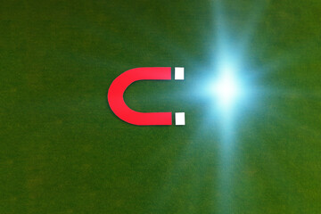 The magnet is red on a green background. Energy production, attraction.