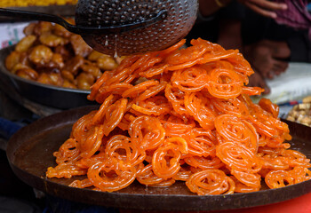 Popular sweet snack of South and Western Asia, named  Jalebi, also known as Jilapi, zulbia, mushabak and zalabia, displayed for Sale. Selective Focus is used.