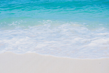 Fototapeta na wymiar Emerald sea wave and white boiling foam surf on the tropical sandy beach