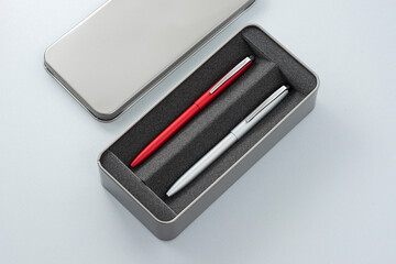 Gray pencil box and pens.