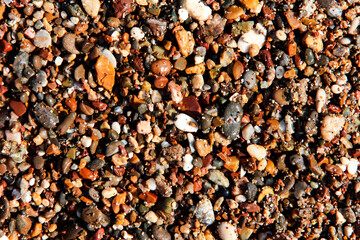 Background from multi-colored stones. Texture of sea stones. Red and blue pebbles. Stone beach. Minerals. Colorful stone. Semiprecious stones. Stereoscopic Cobblestone.
